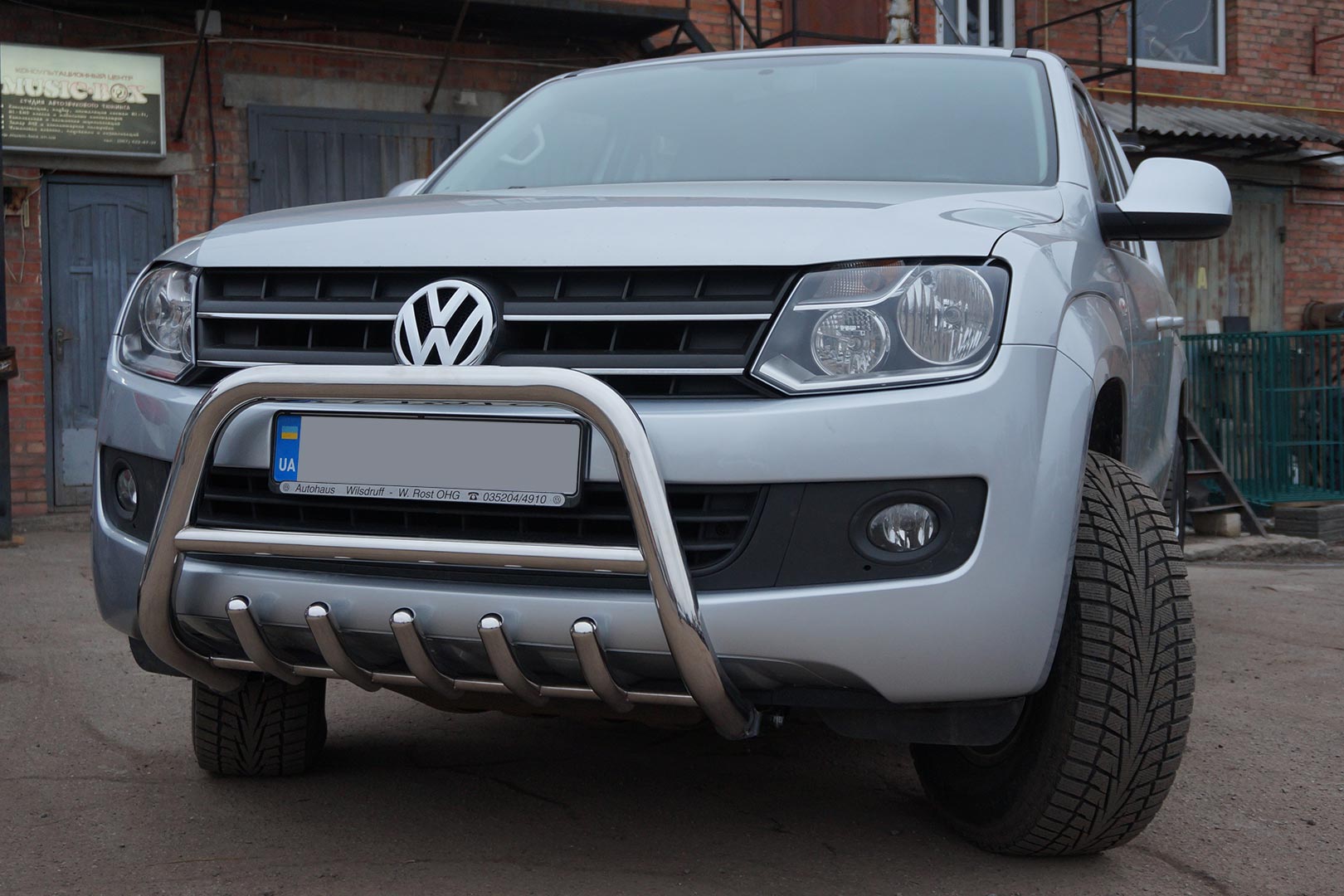 Photo of VW Amarok with bumper protection, side skirts, hardtop and trunk insert